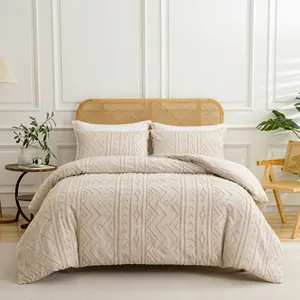 Detail of cream bedding set with geometric quilted patterns in a cozy bedroom setting