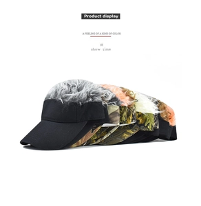 Multiple camouflage and black baseball hats with integrated hair extensions in various colors