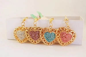 Detailed view of heart-shaped keychains with white, purple, blue and pink rhinestones