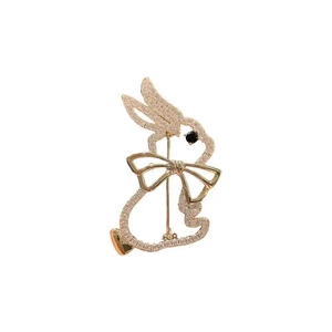 Close-up of golden rabbit brooch with crystals and mother of pearl detail
