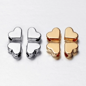 Set of four heart-shaped metal spacer beads in gold and silver finish for DIY jewelry making