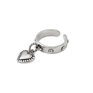Minimalist silver open ring with beaded band and heart-shaped pendant on white background