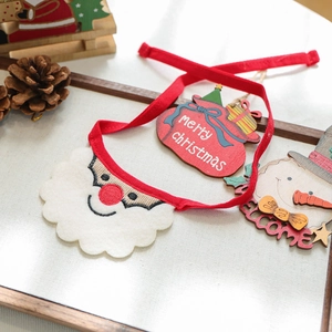 Detail of Christmas pet bib with felt Santa Claus head and festive red ties