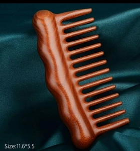 Macro detail of sandalwood massage comb with wide teeth and wave shape 11.6x5.5cm