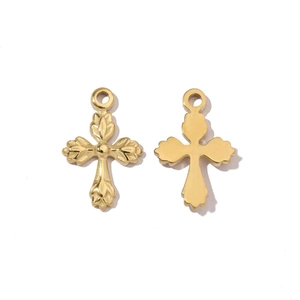 Detailed macro view of golden cross pendants with leaf engraving and smooth mirror finish