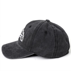 Detail of washed cotton baseball cap with vintage distressed texture and embroidery