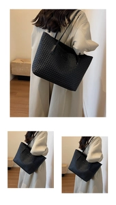Detailed view of the black woven texture and large capacity on this leather tote bag