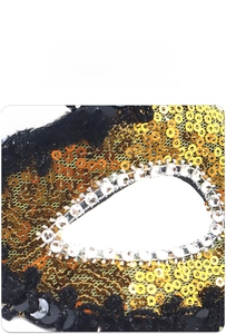 Macro shot of gold sequins and clear rhinestones on a Venetian phantom half mask