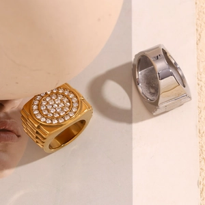 Macro shot of gold and silver signet rings with micro-pave cubic zirconia inlay