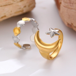 Detail of adjustable 18K gold and silver plated rings with shell and celestial motifs