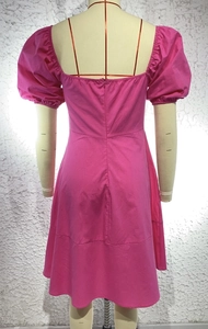 Detail view of the puff sleeves and back invisible zipper on a rose pink dress