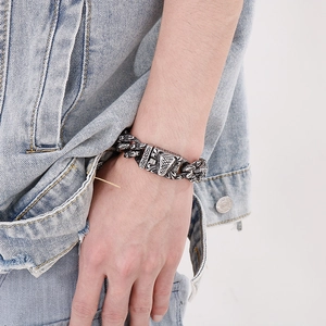 Close-up of vintage titanium steel cuban link bracelet with gothic beast head carving