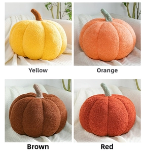 Detail showing plush boucle pumpkin cushions in ginger, orange, brown, and red colors