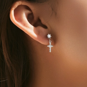Elegant s925 silver cross dangle earrings with sparkling zircon on a female model
