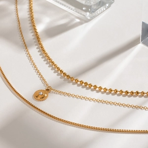 Gold multi-layer stainless steel necklace with bead chain and sparkling crystal pendant
