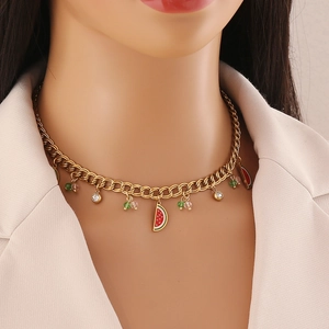 Golden Cuban link necklace featuring colorful crystal watermelon slice pendants on a model