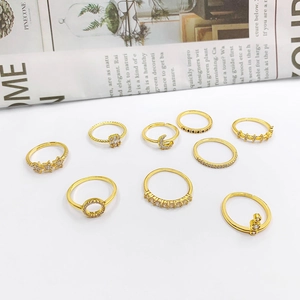 Set of 9 gold-toned rings with moon, star, and zircon inlay designs on a clean background