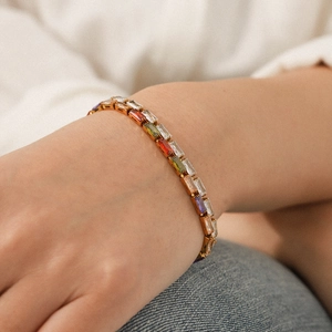 Close-up of rainbow zircon tennis bracelet in 18K gold plated stainless steel on wrist
