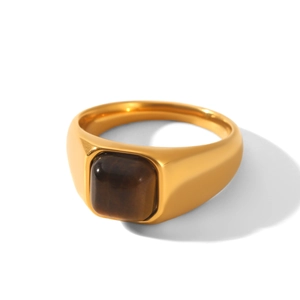 Detailed macro view of gold-plated stainless steel signet ring with brown gemstone inlay
