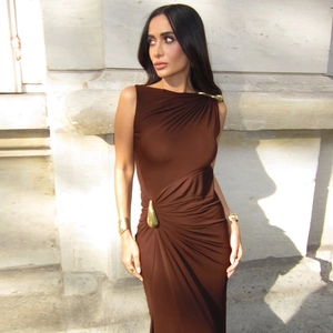 Detail of sleek brown sleeveless dress with gold drop-shaped metal accents and pleats