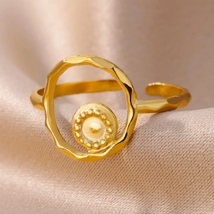 Macro detail of a 18k gold plated stainless steel ring with hammered texture and beaded edges