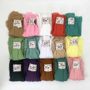 Detailed grid view of 15 color options for pleated scarves with frayed fringe edges