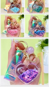 Detail of heart liquid glitter keychain featuring colorful sequins and laser ribbon charms