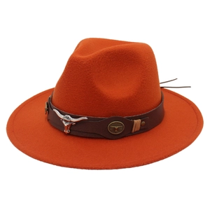 Detail of orange wool fedora featuring brown leather band and silver longhorn metal ornament
