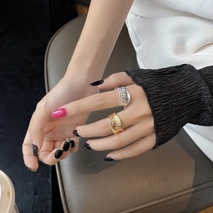 Detailed view of irregular hammered texture on gold and silver minimalist open rings