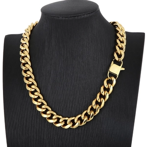 Detail of chunky gold-plated Cuban chain necklace with lobster clasp on neck bust