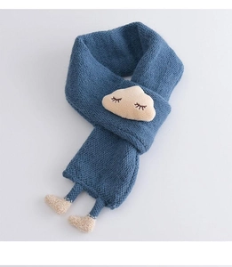 Detail of blue knitted toddler scarf with cute plush cloud face and small soft feet