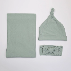 Detail view of newborn swaddle set in sage green featuring soft ribbed knit fabric texture