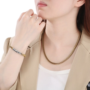 Vintage titanium steel Cuban link chain necklace and bracelet set worn by a model