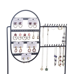 Detail of black metal jewelry organizer displaying earrings and necklaces on white background