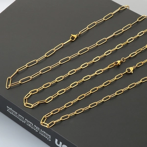 Three gold paperclip link chain necklaces with lobster clasps on a premium black background