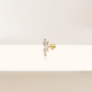 Macro detail of gold S925 silver stud earring with marquise stones and heart design