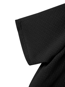 Close-up of black breathable waffle weave fabric texture on men's athletic T-shirt