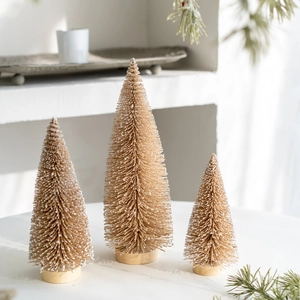 Set of three champagne mini Christmas trees with snow flocking and wooden bases