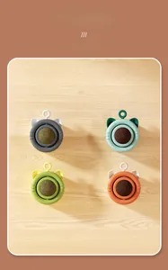 Detail showing four colors of rotating catnip wall balls with cute cat ear design and covers