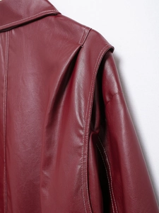 Detailed close-up of dark red leather jacket with white contrast stitching and fine grain texture