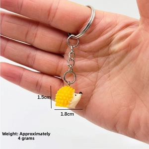 Detailed size view of yellow hedgehog keychain showing 1.5cm x 1.8cm dimensions