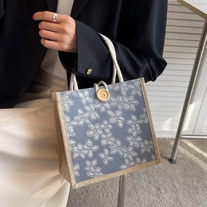 Floral print canvas lunch bag with braided wood trim and sturdy white rope handles