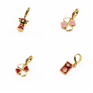Detailed view of gold enamel charms featuring Four-leaf Clover and Fortune symbols
