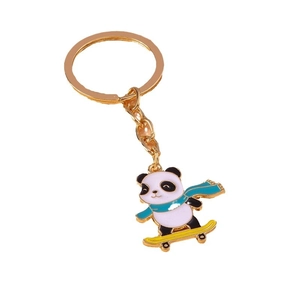 Creative cartoon panda keychain with blue scarf and yellow skateboard on a gold ring