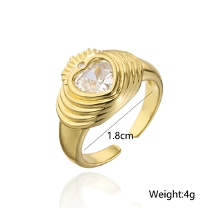 Detail of gold open ring featuring a heart zircon, rippled texture and 4g weight display