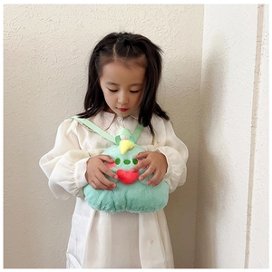 Close-up of a cute green plush backpack for kids with soft texture and doll design