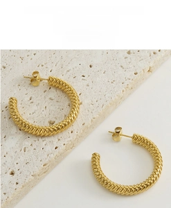 Macro shot of 18k gold plated stainless steel twisted rope earrings with butterfly back
