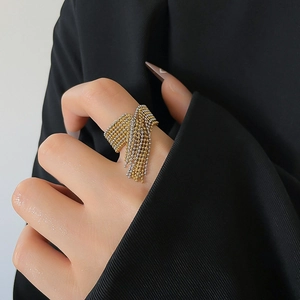 Detailed view of fashionable beaded tassel ring in gold and silver mix on model finger