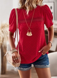 Detail of red hollow embroidered fabric and round neck on a casual short sleeve summer top