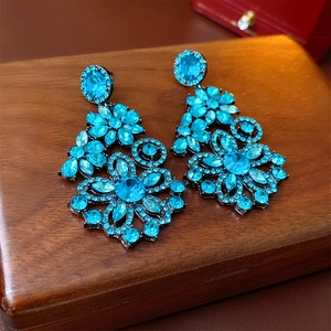 Elegant vintage blue floral crystal dangle earrings on a premium wood texture